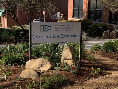 Sign reading "DURHAM COUNTY Agriculture Building 721 FOSTER STREET Cooperative Extension"