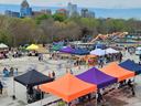 Community outdoor festival with colorful vendor tents and "SPINNING PLATE" food truck