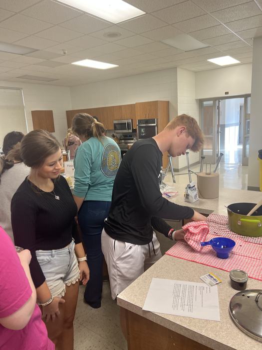 Teenagers can on red and white towels.