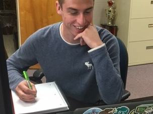 Issac Wyatt sitting at his desk.