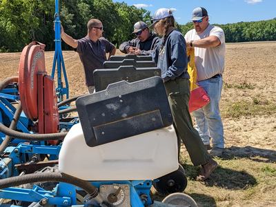 Researchers around a planter