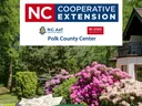 Garden with flowering shrubs and house; banner: NC Cooperative Extension Polk County Center