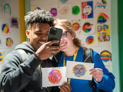 Youth pose together at the 4-H Ignite conference. Many teens use their cell phones or other devices to access social media like YouTube.