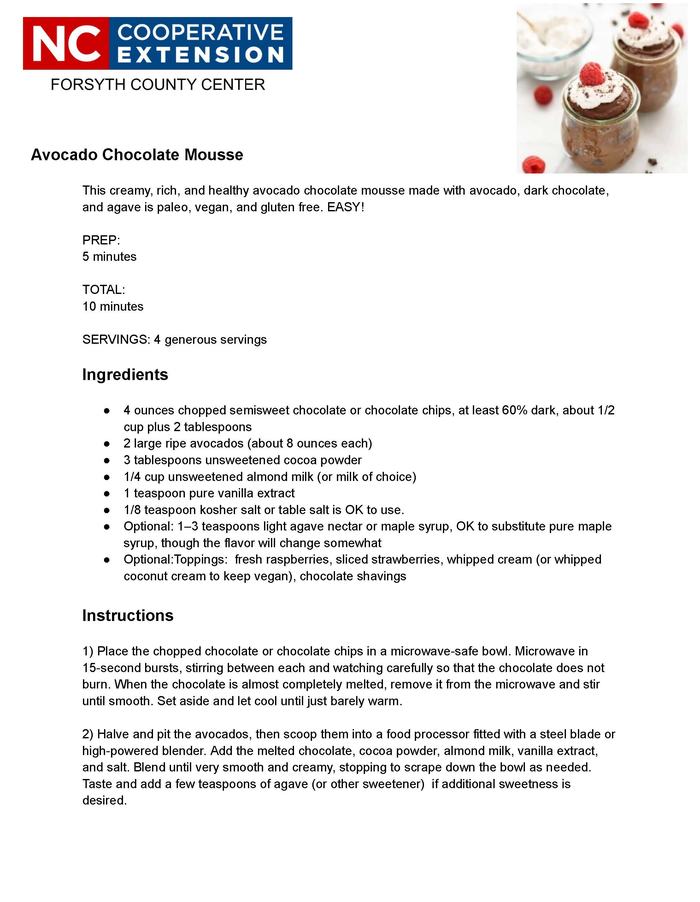 a chocolate mousse topped with whipped cream and a raspberry.