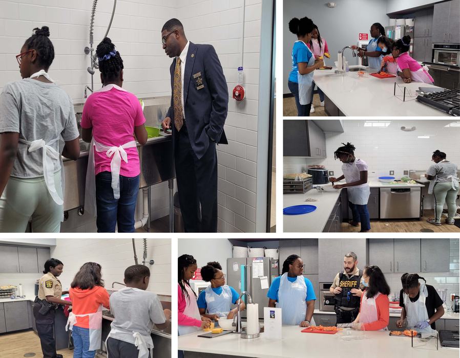Sheriff's deputies help kids in a kitchen.