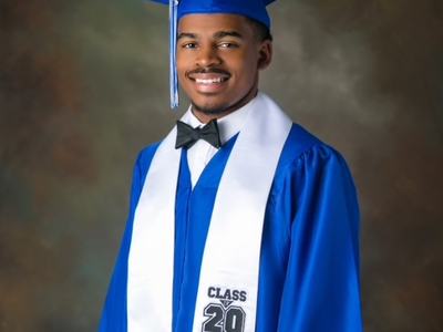 A man in a graduation gown and cap.