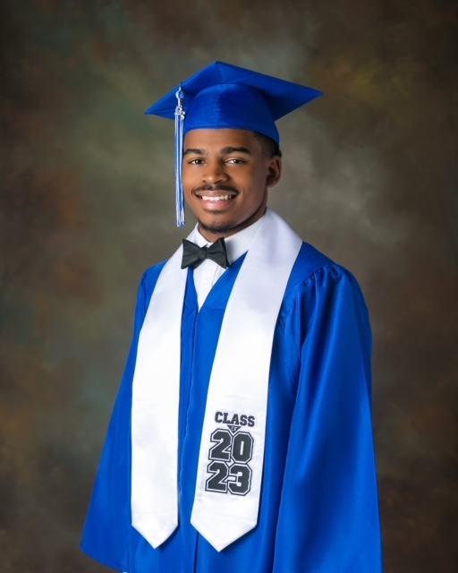 A man in a graduation gown and cap.