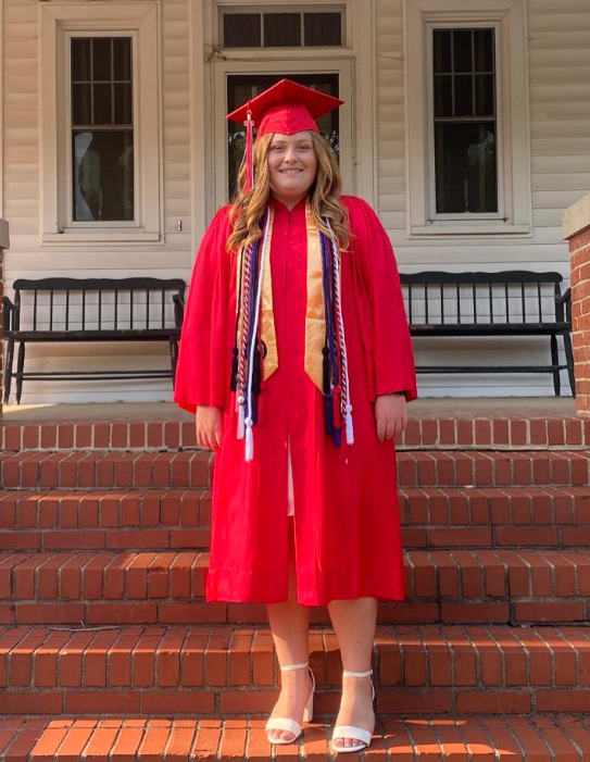 A woman in a graduation gown.