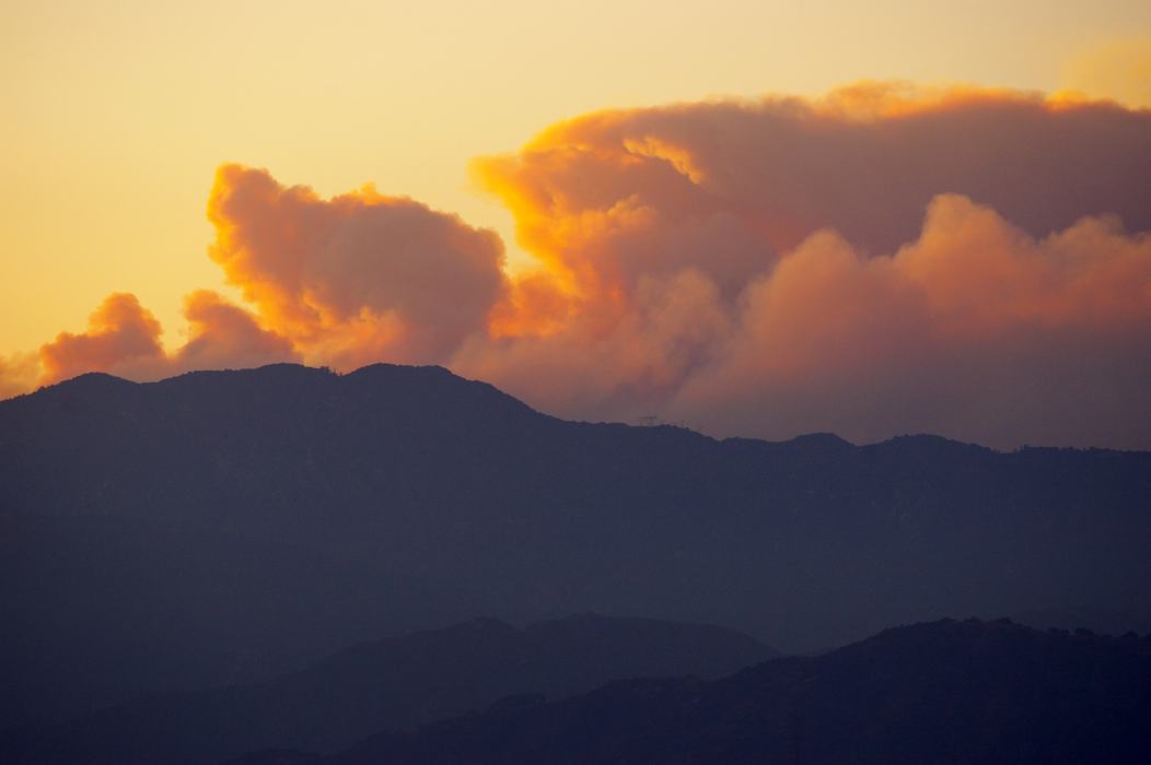 Smoke from forest fires over a mountain.