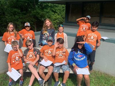 Group of kids sit together at summer camp
