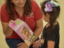 Adults showing a child a nutrition flyer