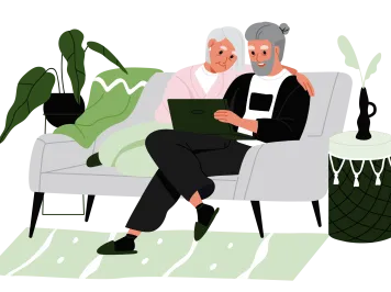 Older man and woman sitting on couch reviewing disaster plans on the computer.