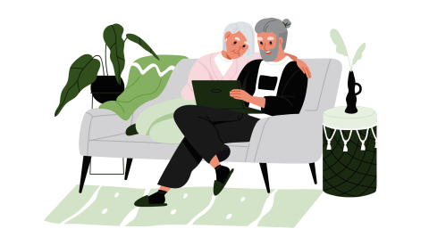 Older man and woman sitting on couch reviewing disaster plans on the computer. 