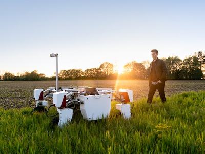 ale mechanical engineer with sustainabMale agricultural robot in field
