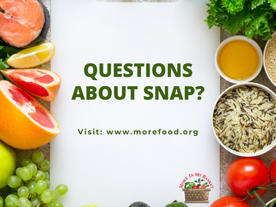 Sign reading "QUESTIONS ABOUT SNAP? Visit: www.morefood.org" surrounded by produce and grains