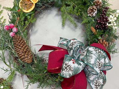 Wreath sample with evergreen, dried oranges, pinecones, and bow