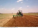 Tractor tilling a field.