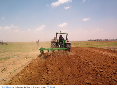 Tractor tilling a field.