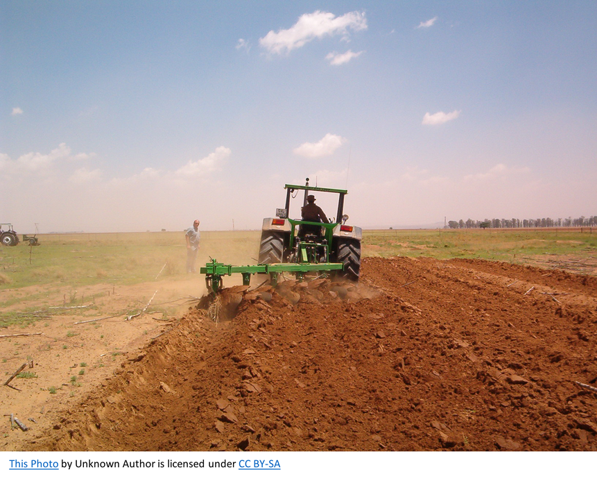 Tractor tilling a field.
