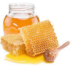 Jar of honey with honeycomb