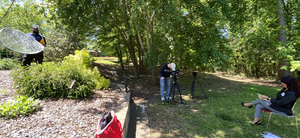 behind the scenes photo showing camera crew setting up a shot