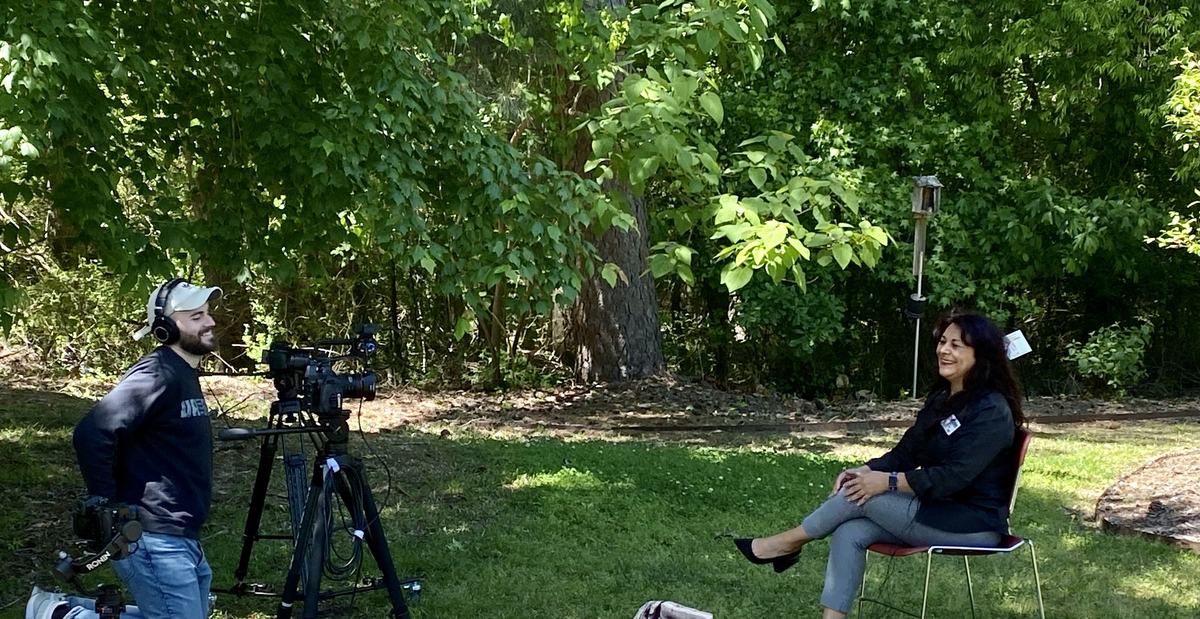 Photo of camera person filming Patty Saltpaw outdoors