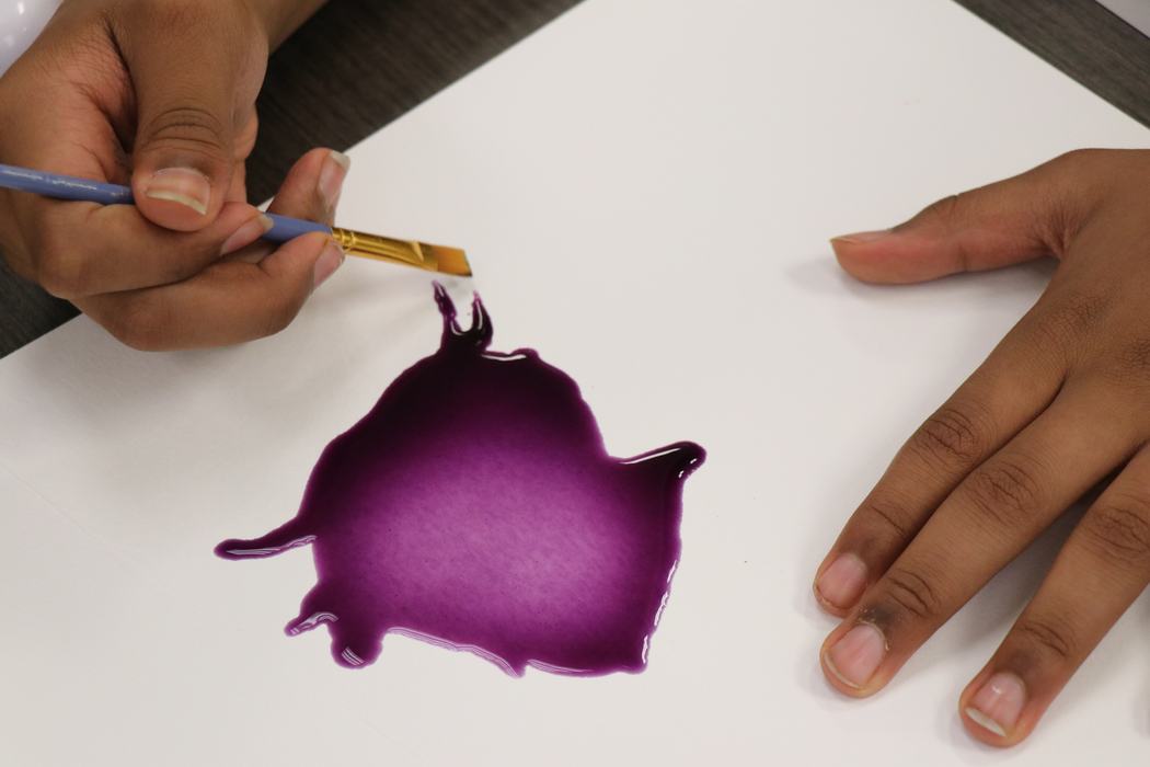 close up of camper painting with purple watercolor