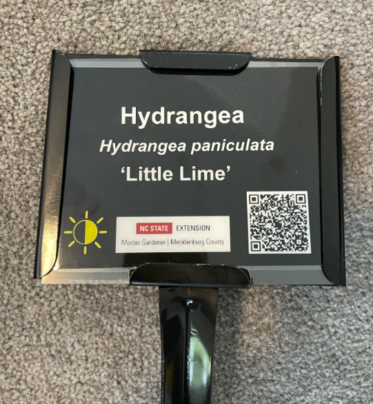 Tag showing the name and QR code & NC Extension logo