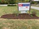 NC Cooperative Extension Henderson County Center sign; lower panel reads "Henderson County 4-H" on lawn