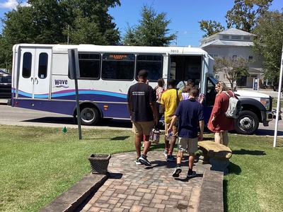 Participants boarding public transportation