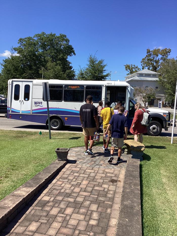Participants boarding public transportation