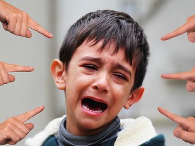 crying child being pointed at