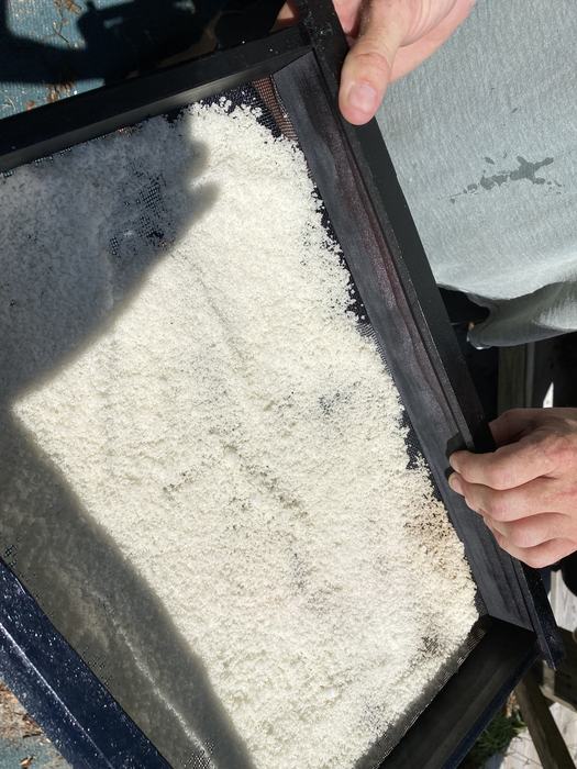 sifting salt to remove impurities