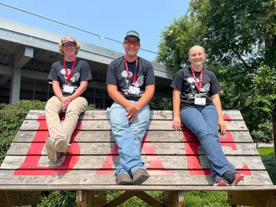 4-Hers at NC State pose for a picture on a tall bench