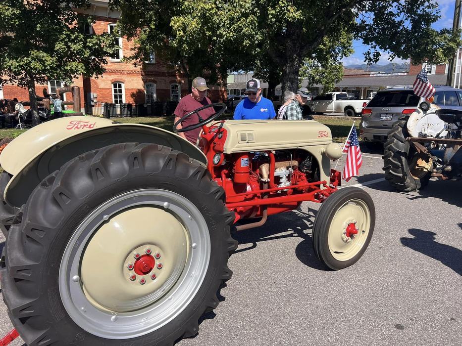 Two participants have a close look at a tractor