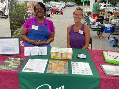 Master Gardener volunteers offer free seed packets at the traveling seed bank at the Mount Holly Farmers Market.