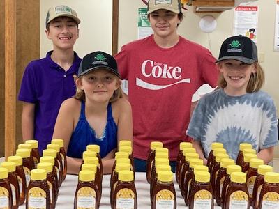 4-H Kids selling honey