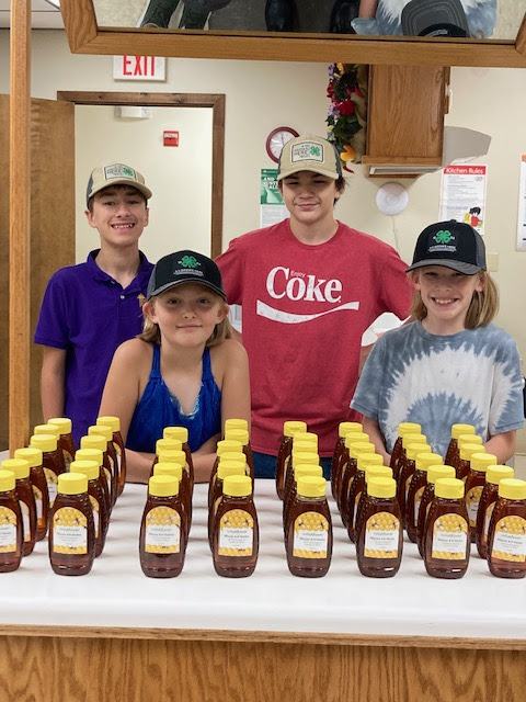 4-H Kids selling honey