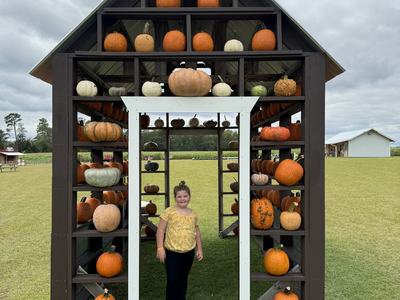 The photo is my daughter, Willa Grace, standing in the Pumpkin House at Stokes Family Farm in Greenville, NC. Photo Credit: Kayla Fox