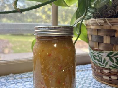 picked green tomato relish in jar displayed near a window