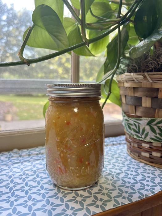 picked green tomato relish in jar displayed near a window