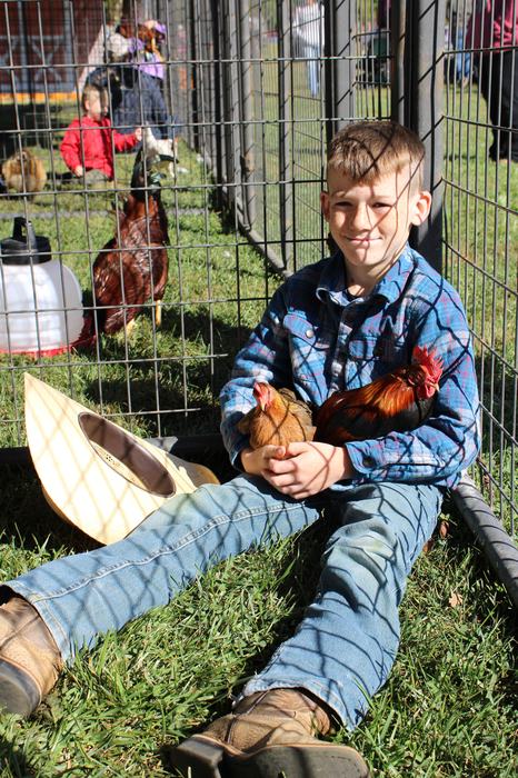 4-H Youth holding a hen and rooster
