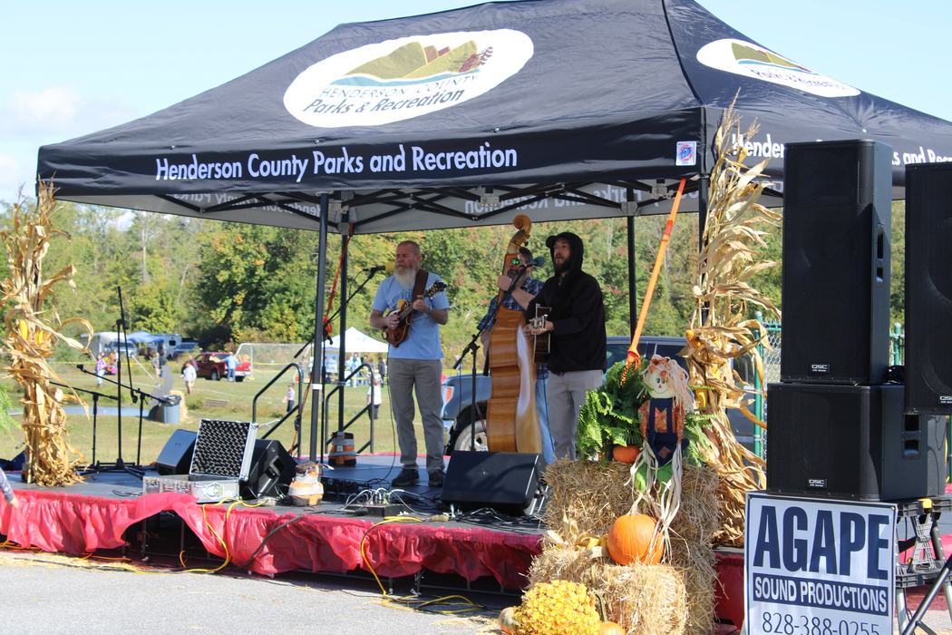 Band with 3 members playing on Farm City Day Stage. 