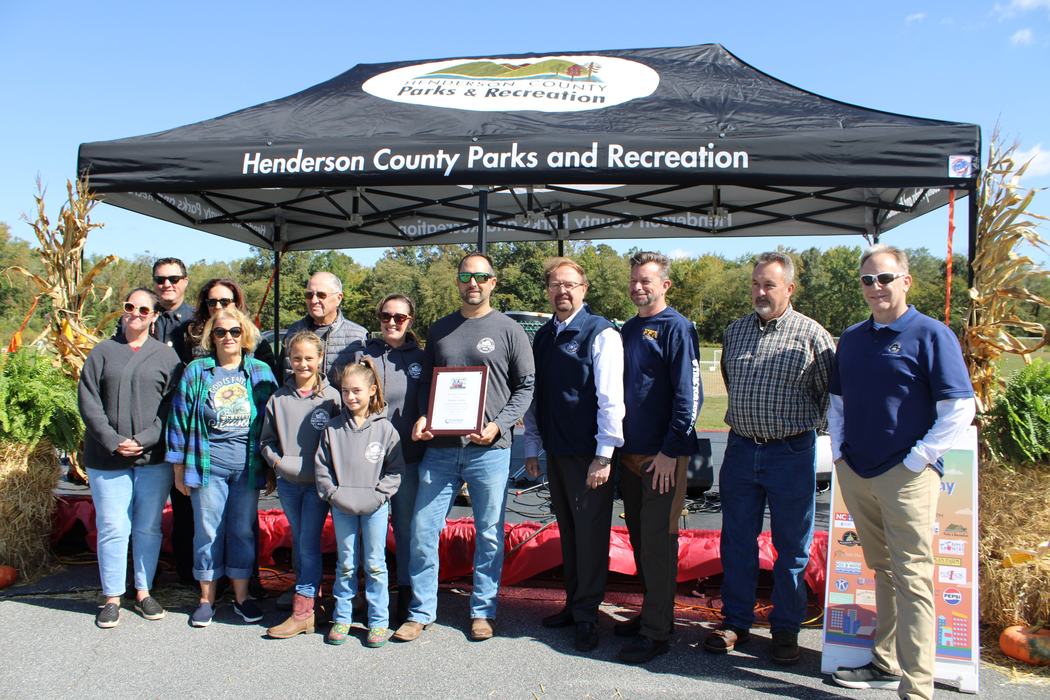 A group poses with an award.