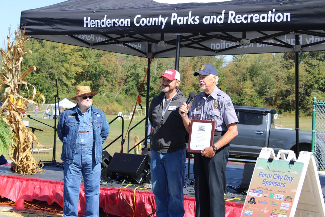 A man is presented with a plaque.