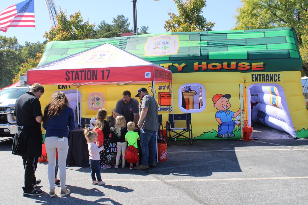 Children wait in line to go into a Fire Station Safety House