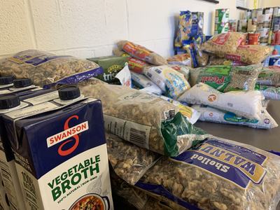 Swanson Vegetable Broth cartons beside bags of walnuts, rice and other packaged foods