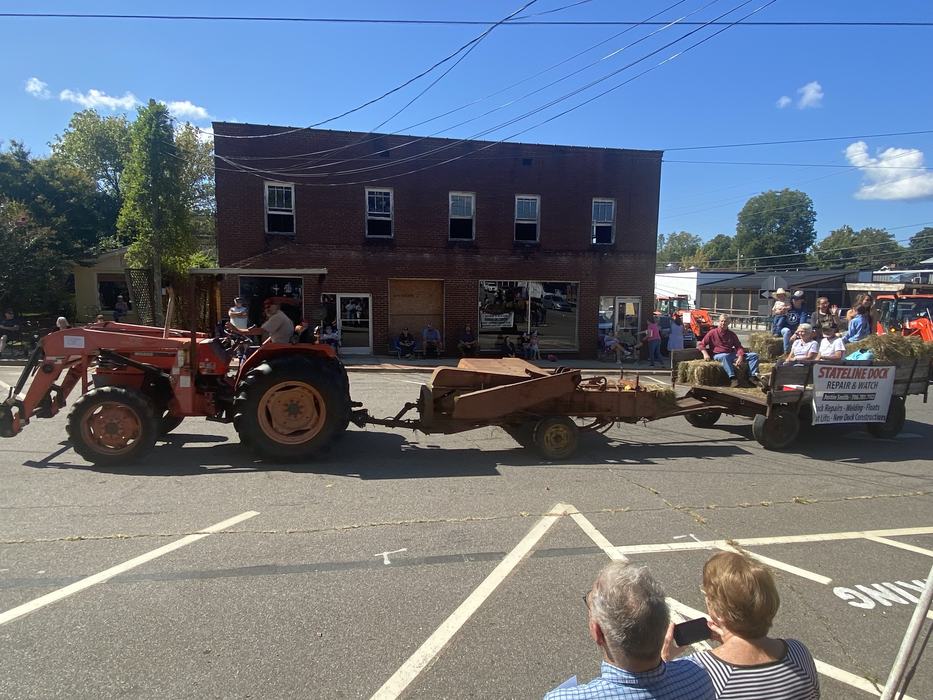 tractor pulling trailer with people