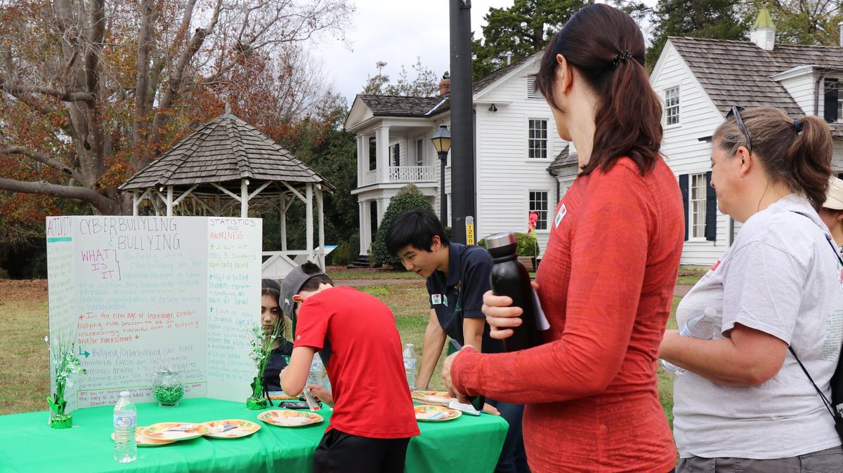 Attendees look at cyberbullying display