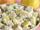 Bowl of pear and chicken salad with celery and raisins on pink cloth; text "www.FOODHERO.org"